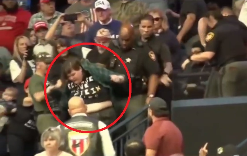 Watch a Woman Get Jumped by Trump’s Loyal Subjects for Wearing a “Release the Epstein Files” Shirt